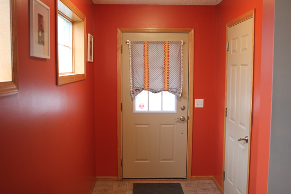 Functional Entryway Makeover with board and batten and dark contrasting doors.