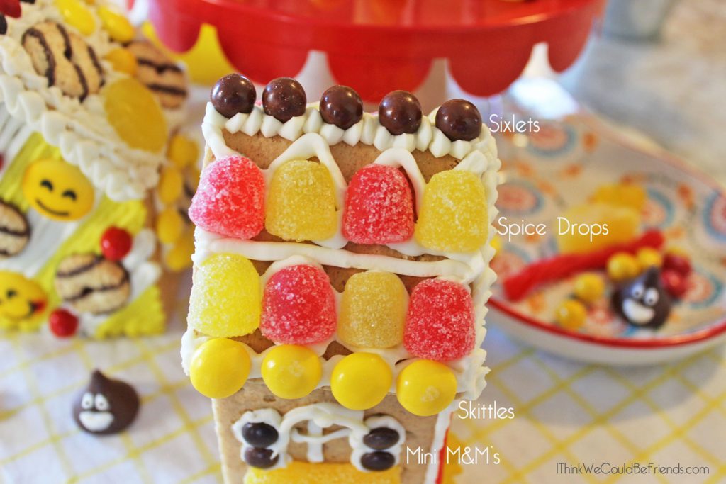 Looking for a fun Emoji Birthday Party idea? Our kids LOVED these Emoji Gingerbread Houses! They are just made from graham crackers and are EASY to make! Also includes a free printable bag topper to make your own Emoji Gingerbread House Build & Decorate kits! #Emoji #Birthday #Party #Ideas #Gingerbread #House #Decorations #Christmas 