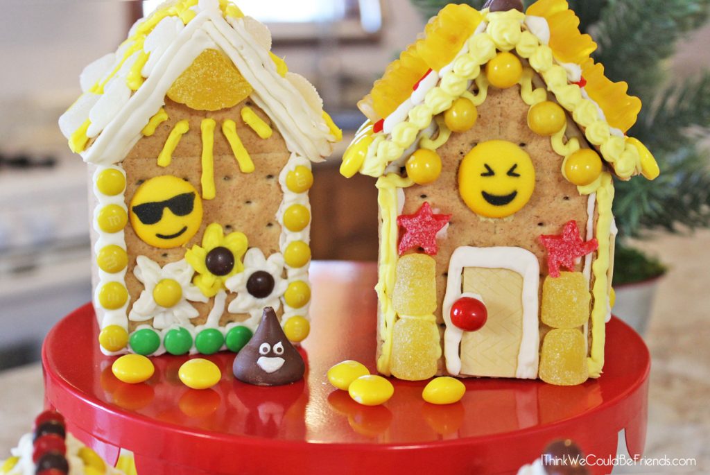 Looking for a fun Emoji Birthday Party idea? Our kids LOVED these Emoji Gingerbread Houses! They are just made from graham crackers and are EASY to make! Also includes a free printable bag topper to make your own Emoji Gingerbread House Build & Decorate kits! #Emoji #Birthday #Party #Ideas #Gingerbread #House #Decorations #Christmas 