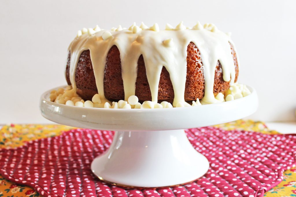 Incredibly RICH and MOIST White Chocolate Vanilla Bundt Cake! Oh, and its EASY, too! It starts with a boxed cake mix and then you add sour cream AND pudding--SO GOOD!!!! #bundt #cake #recipe #white #chocolate #vanilla