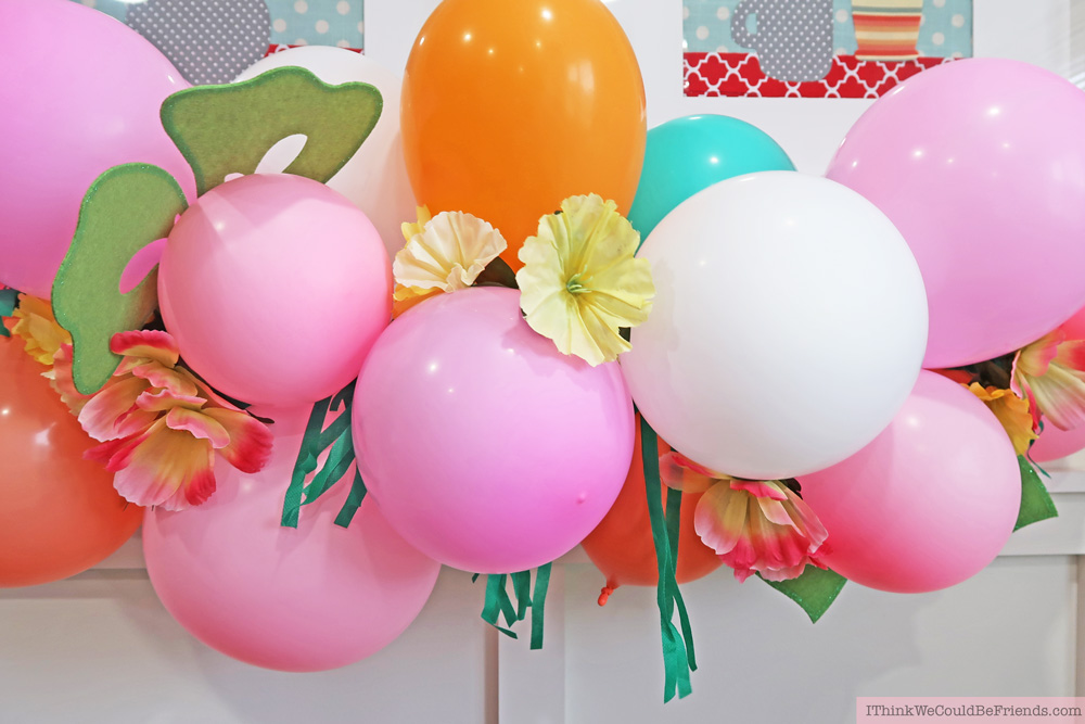 DIY Tropical Balloon Garland! Cheap but TASTEFUL Flamingo Party Decoration Ideas, using ALL items from the Dollar Tree! We hosted a beautiful Flamingo Baby Shower for my sister that didn't break the bank!!! Everyone LOVED the flamingo theme and especially the DIY Tropical Balloon Garland, flamingo cupcake topper and a FREE printable! #flamingo #party #decoration #ideas #DIY #balloon #garland #free #printable #cheap #easy #baby #shower #bridal #kids