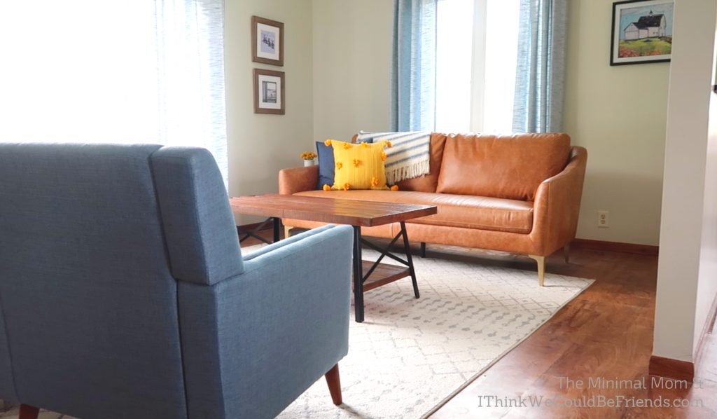 minimalist living room, brown couch, blue chair