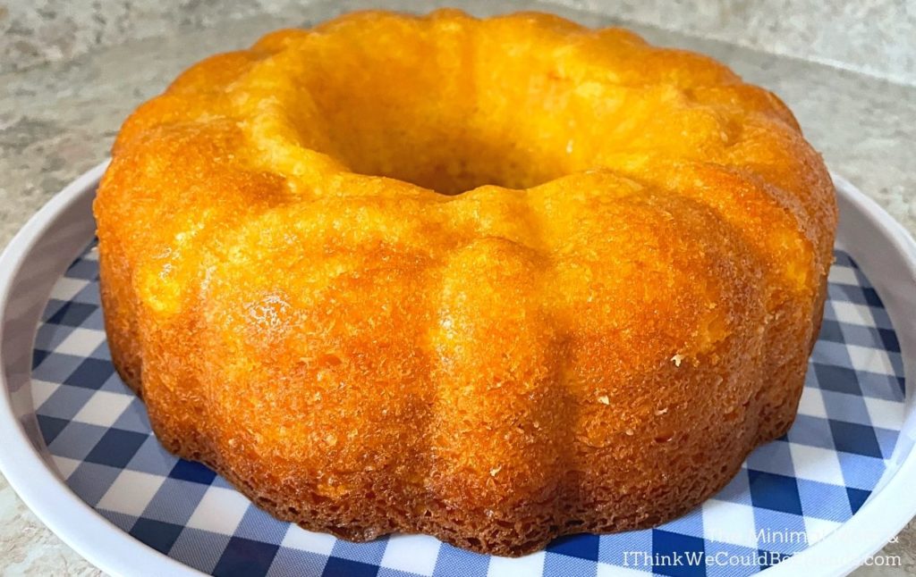 lemon bundt cake fresh out of pan on checkered platter