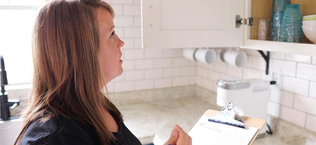 inventory checklist, Dawn looking in cupboard with clipboard